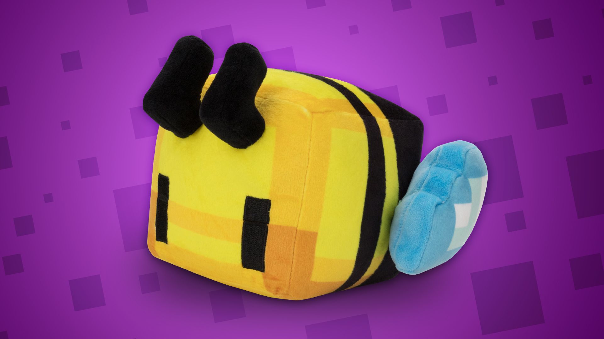 Image of the Cubee plush. A cube-shaped bee, made of bright yellows, oranges and black stripes.
